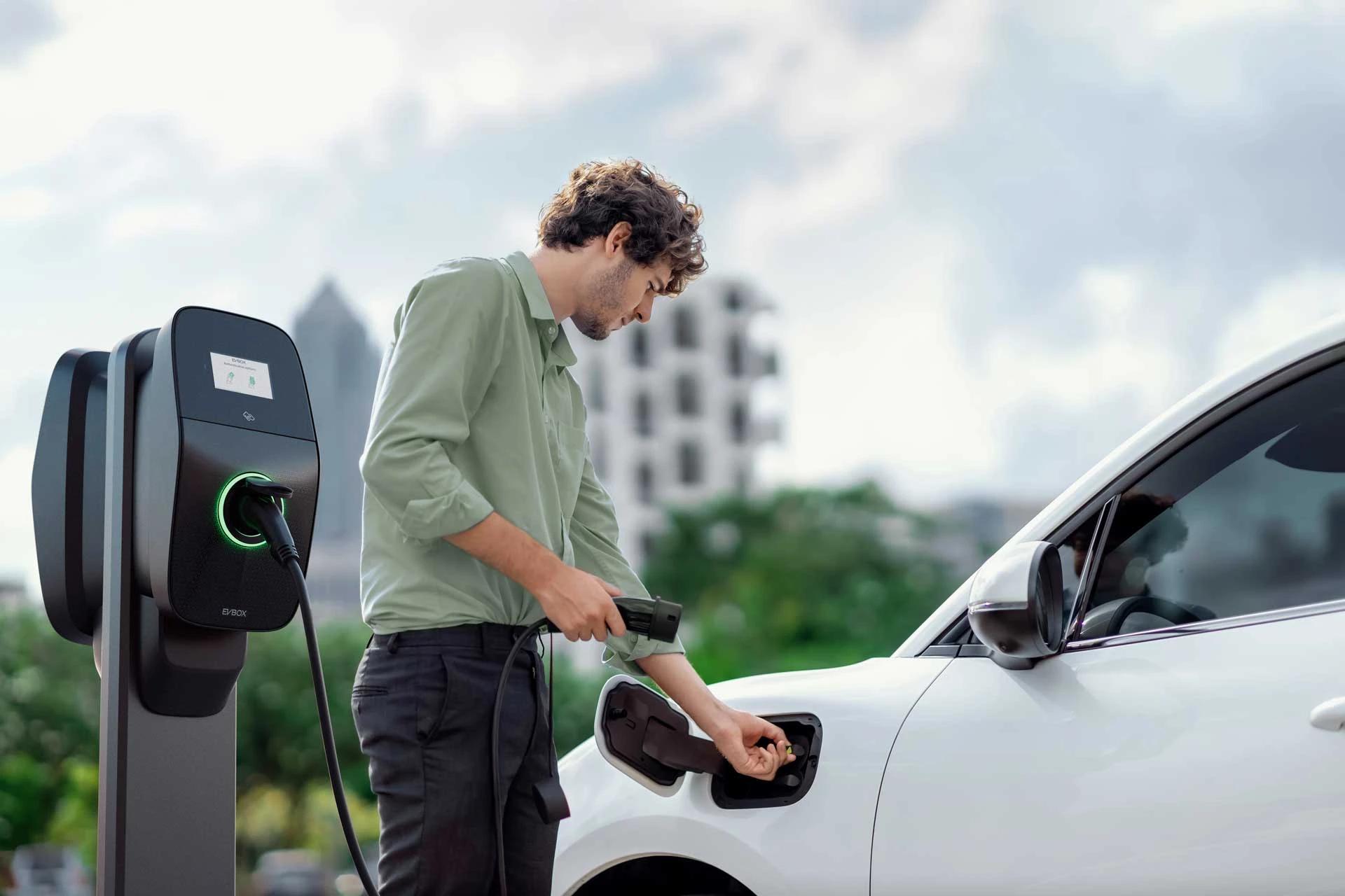The person connecting the electric charger to the vehicle